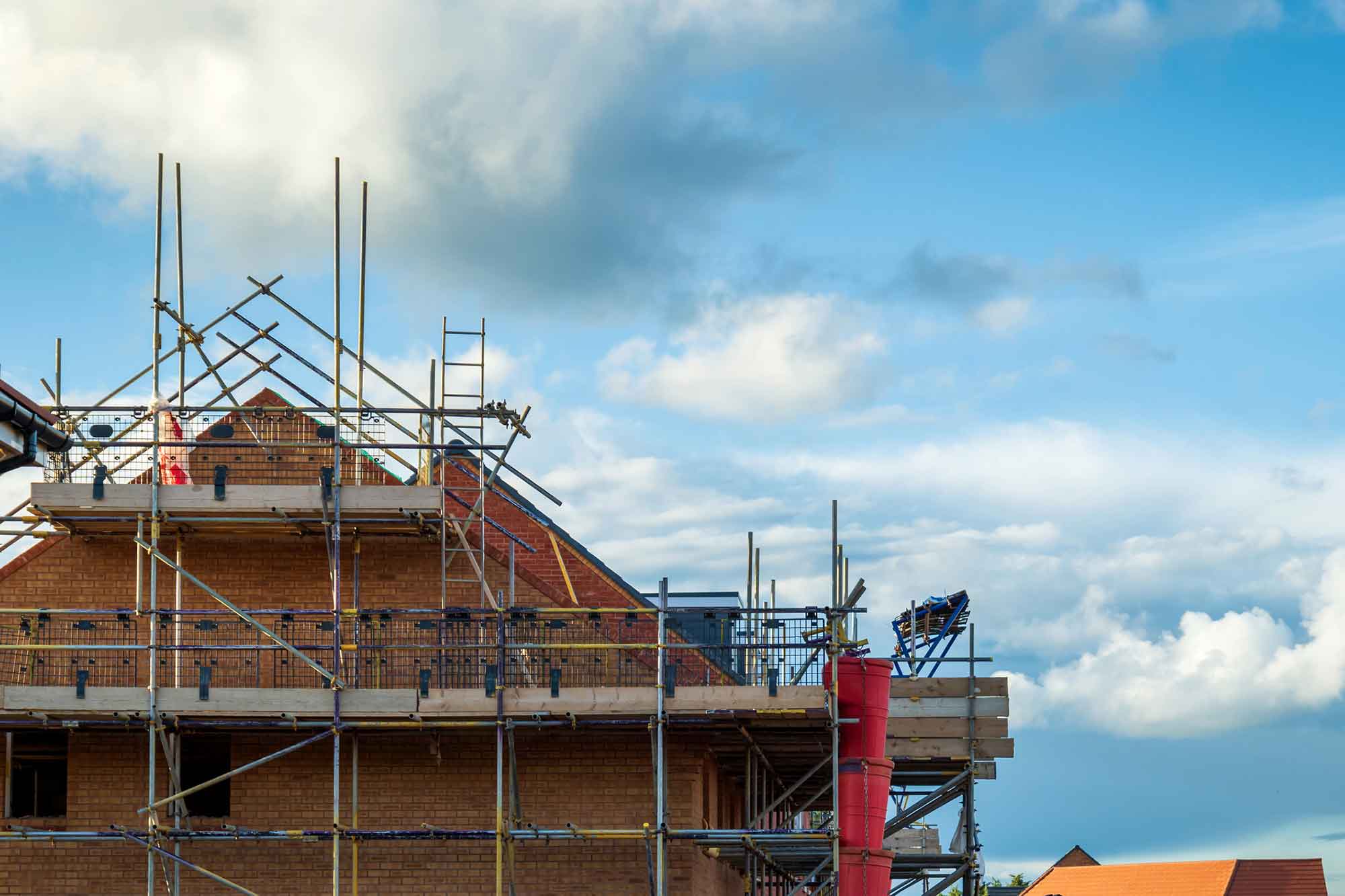 New house building in UK with cloudy blue sky